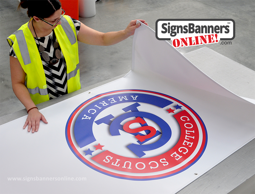 CSA logo on a banner sign with factory person inspecting the print and image of the custom vinyl banner sign. Beaverton Oregon USA