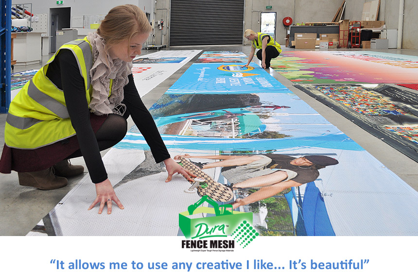 A girl looking at the long banner printing and creative sign printing used around the packaging department of all the colors on the banner signs.