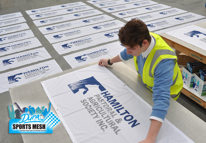 Inside the factory with hundreds of locality signage flags being processed.