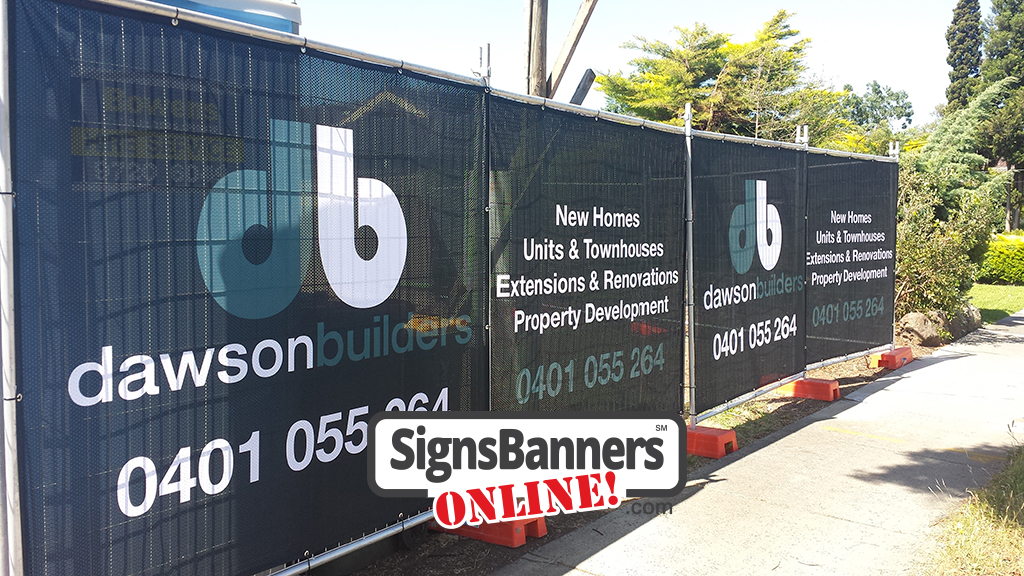 Angled photo of medium banner prints customize to suit your barrier fence or rental fencing structures, these custom banner signs are printed on mesh material for a building company.