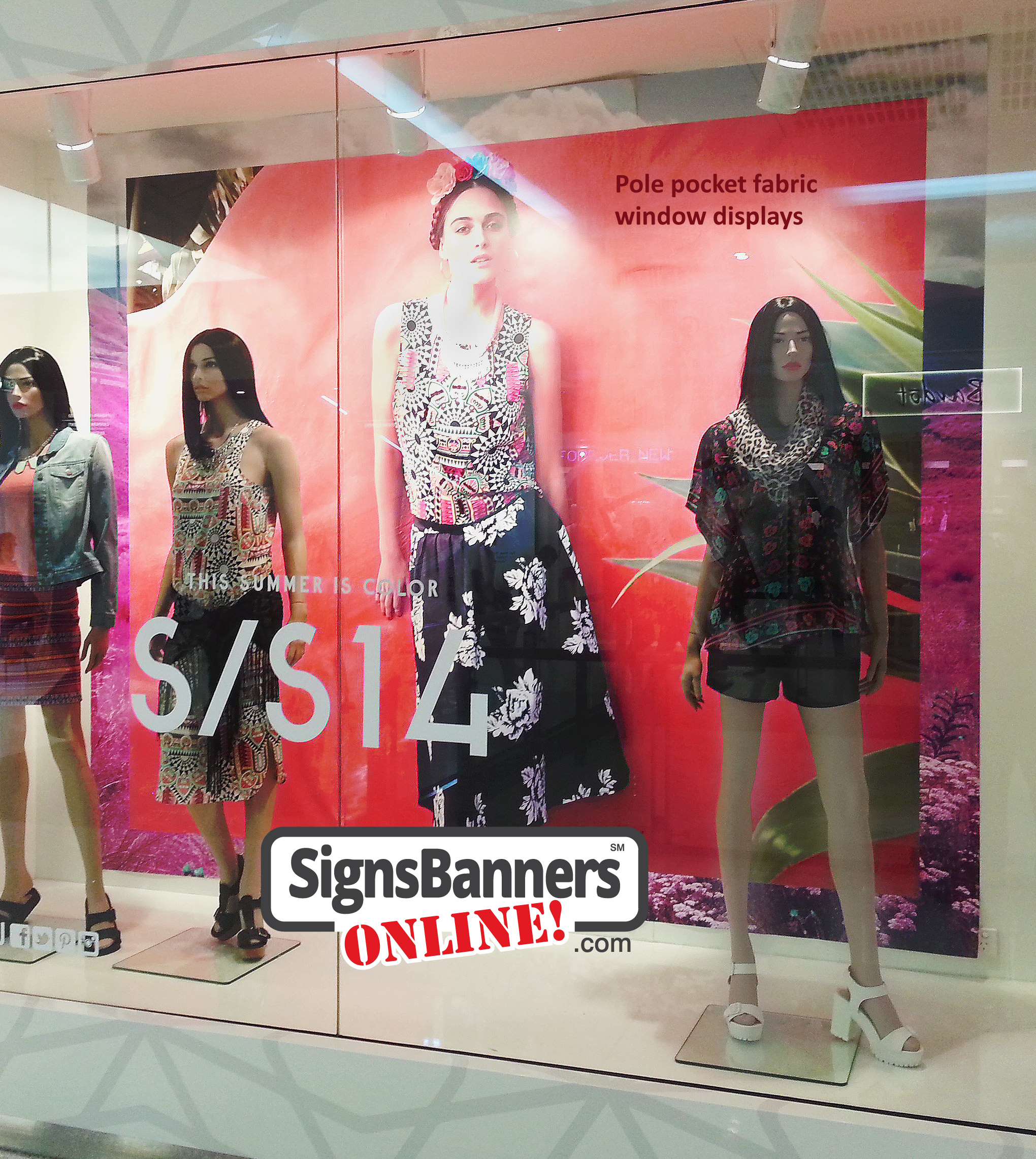 Large piece window display banner for advertising clothing store signage in a mall