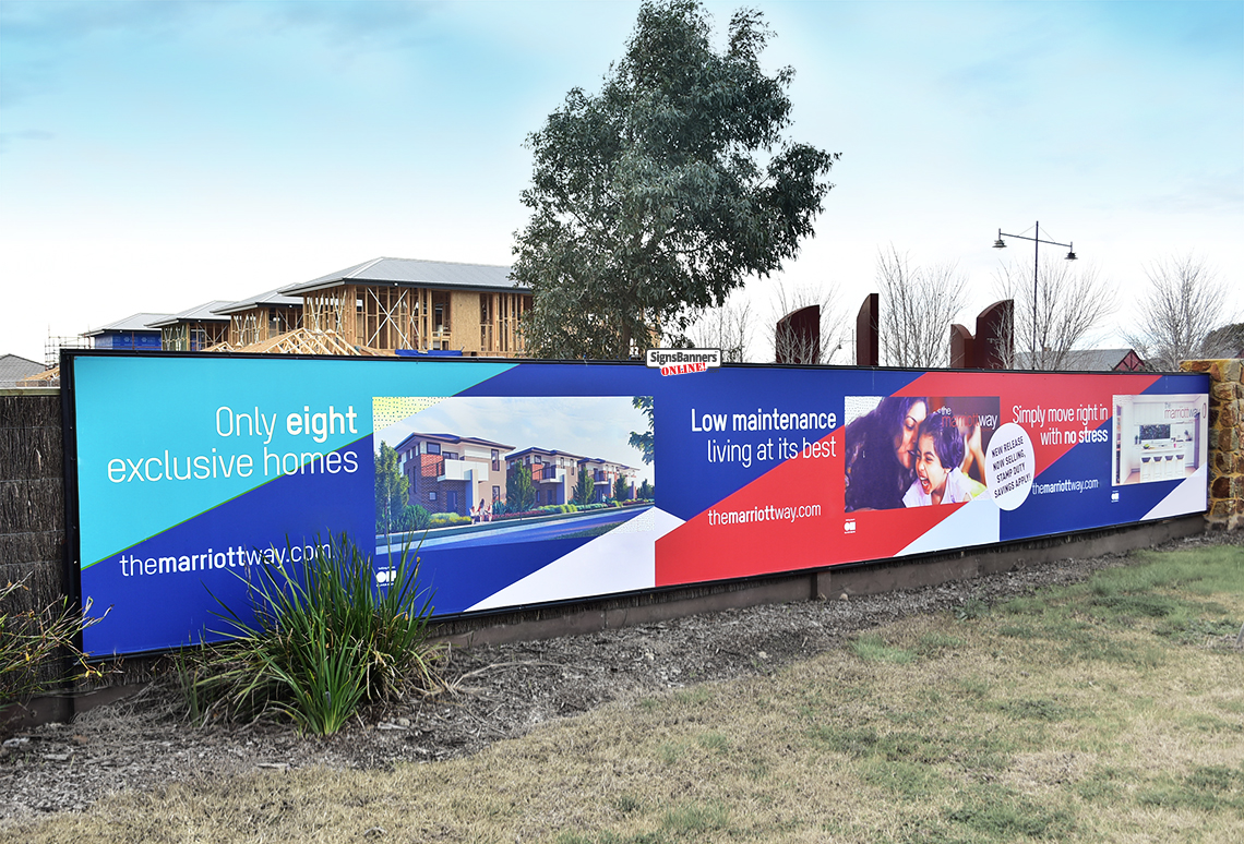 Real Esate Sales Office Banner on fence with new housing in background