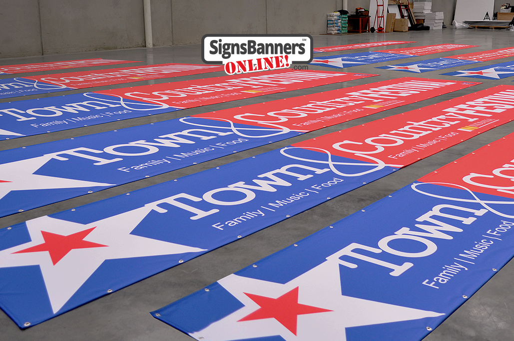 Banners and flags laid out on the packing floor ready to ship out to festival management company