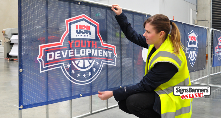 Portable outdoor display banner signs USA. Zip onto the crowd rail, these dark mesh banner signs with USA Basketball Youth Development logo look amazing. Factory Made.