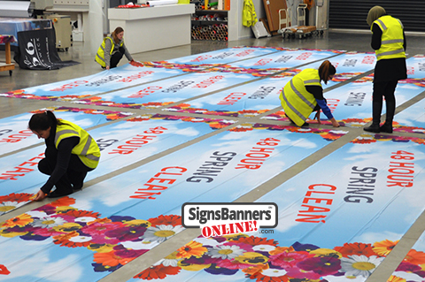 Some of the crew looking at the banner sign factory products and inspect quality checks